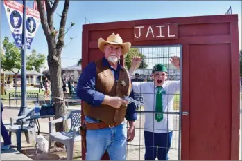  ?? RECORDER PHOTO BY JAMIE A. HUNT ?? For some reason Tulare County Fifth District Supervisor Dennis Townsend, aka Sheriff Dennis Townsend, decided to throw this fine young man, Elijah Miller, 12, into jail on Saturday during Pioneer Days.