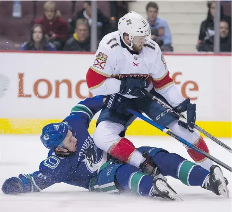  ?? GERRY KAHRMANN ?? Vancouver Canucks defenceman Troy Stecher brings down Florida Panthers left wing Jonathan Huberdeau in the second period on Wednesday night at Rogers Arena. Stecher earned a holding penalty on the play, and the Canucks went on to lose 4-3.