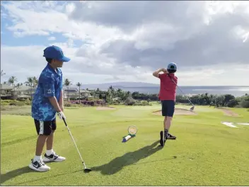  ?? US KIDS GOLF photo ?? Kyle Trudell tees off on Wailea Blue Course’s seventh hole as Evan Patel watches during a US Kids Golf local tour event last weekend.