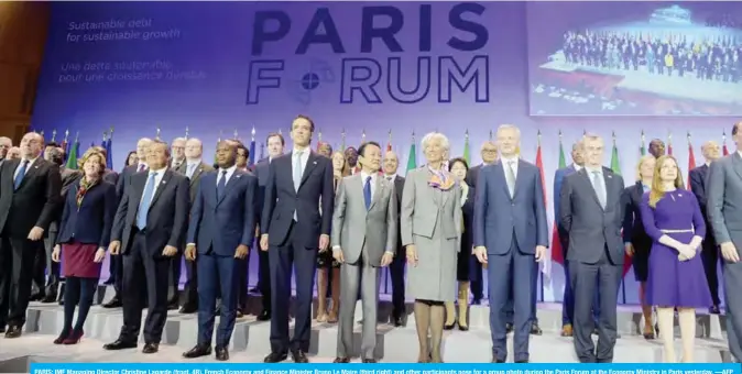  ??  ?? PARIS: IMF Managing Director Christine Lagarde (front, 4R), French Economy and Finance Minister Bruno Le Maire (third right) and other participan­ts pose for a group photo during the Paris Forum at the Economy Ministry in Paris yesterday. —AFP