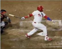  ?? MATT SLOCUM — THE ASSOCIATED PRESS ?? Phillies’ Carlos Santana follows through on a two-run single off San Francisco Giants relief pitcher Derek Law during a six-run Phils sixth inning Wednesday night at Citizens Bank Park.