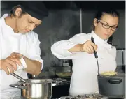  ??  ?? HOME COOKING: Husband and wife team Miles and Itami Reolon, who own Seasoned, prepare dinner for a private client