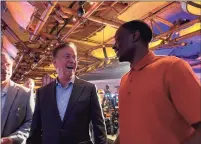  ?? Mike Anthony / Hearst Connecticu­t Media ?? Gov. Ned Lamont talks to former UConn football player Darius Butler, who played nine years in the NFL, at Mohegan Sun casino Thursday morning.