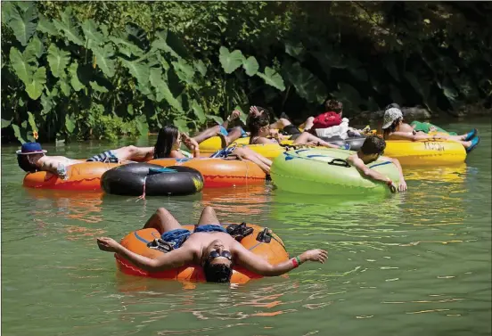  ?? JAY JANNER / AMERICAN-STATESMAN ?? Jorge Rosas of Houston relaxes in the San Marcos River during Float Fest.