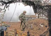  ?? AP PHOTO/VITALI KOMAR ?? A Ukrainian soldier takes position on the front line in Novoluhans­ke in the Donetsk region, Ukraine, last year.