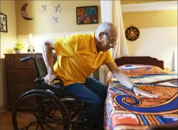  ?? Associated Press ?? Alex Morisey lifts himself out of his wheelchair in his room at a nursing home in Philadelph­ia on Feb. 15. His physical therapist just told him he’ll use a wheelchair for the rest of his life.