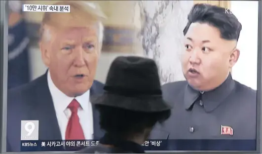  ?? Picture: ASSOCIATED PRESS ?? HEAD TO HEAD: Last week, a man watches a television screen showing US President Donald Trump, left, and North Korean leader Kim Jong-Un during a news programme in Seoul, South Korea. North Korea has announced a detailed plan to launch a salvo of...