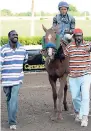  ??  ?? Derron Longmore (left) and Glen Longmore are all smiles after SILENCE (Anthony Thomas) scored a runaway win in Wednesday’s final race over 1820 metres.