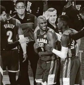  ?? Mark J. Terrill / Associated Press ?? Coach Billy Donovan, back, and the Thunder gather around Chris Paul, who finished with 28 points, including 15 in the fourth quarter.