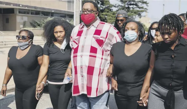  ??  ?? 0 Jacob Blake, Sr, and Julia Jackson (second right), parents of Jacob Blake, Jr, with relatives outside the county courthouse in Kenosha, Wisconsin