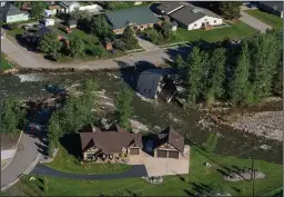  ?? ?? A house sits in Rock Creek on Thursday after floodwater­s washed away a road and a bridge in Red Lodge, Mont. Just three months prior, the region was in the middle of an extended drought.