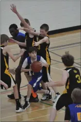  ?? ?? Irvine's Ethan Bowey, Ethan Hansen, Parker Bellamy, and Cayden Payeur provide a wall of coverage underneath their basket against the Alexandra Jayhawks.