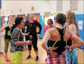  ??  ?? Event organizer Mayumi Kato giving her fellow instructor­s a pep talk before the second annual Zumbathon Charity Event for the American Diabetes Associatio­n on Sunday at Saratoga Springs High School.