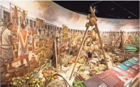  ?? DENIS FINNIN ?? This re-creation within the “Global Kitchen” exhibit represents a small corner of a giant marketplac­e that served the capital city of the thriving Aztec Empire in what is now Mexico. It depicts the year 1519, when Spanish explorer Hernán Cortés is...