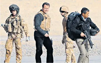  ??  ?? David Cameron in Afghanista­n, 2009. His government introduced the defence cuts