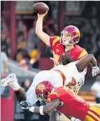  ??  ?? SAM DARNOLD, getting off a pass in the first quarter, helps USC defeat Texas.