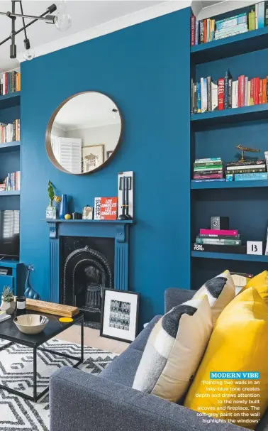  ??  ?? modern vibe ‘Painting two walls in an inky-blue tone creates depth and draws attention to the newly built alcoves and fireplace. The soft-grey paint on the wall highlights the windows’