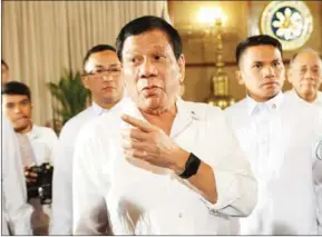  ?? TED ALJIBE/AFP ?? Philippine President Rodrigo Duterte (centre) gestures as he talks to members of the media after a joint press conference with Senate President Aquilino Pimentel III and Speaker of the House Pantaleon Alvarez (not pictured) at Malacanang Palace in...