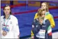  ?? DARKO BANDIC — ASSOCIATED PRESS ?? Italy's Federica Pellegrini, front right, kisses her medal as United States' silver medal winner Katie Ledecky, left, looks on after the women's 200-meter freestyle final on Wednesday.