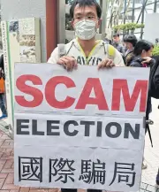  ?? AFP ?? A pro-democracy activist protests outside the venue of the Hong Kong chief executive election yesterday.