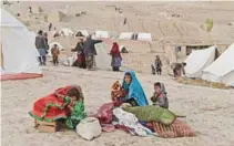  ?? - AFP file photo ?? ILLEGAL MINING Afghan villagers sit near tents in Argo district of Badakhshan province in northeast Afghanista­n. Illegal mining is common in resource-rich Afghanista­n, with the Taliban relying on the sector for much of its revenue.