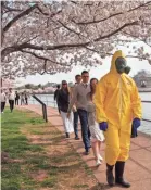  ?? JACQUELYN MARTIN/AP ?? A 17-year-old and his family visit Washington, D.C., on Sunday.
“I’m not worried for me since I’m young,” he says of his protective gear. “I’m wearing this in case I come into contact with anyone who is older.”