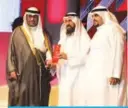  ??  ?? Ibrahim Fouzan (center) receives a memento commemorat­ing Al-Sayer Group’s participat­ion in the event.