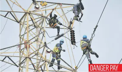  ?? Picture: Michel Bega ?? Rope climbers are seen replacing old conductors on an electricit­y pylon in Bosmont yesterday.