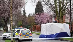  ??  ?? Hunt for clues: A forensics tent at the scene yesterday