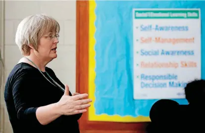  ?? [PHOTOS BY SARAH PHIPPS, THE OKLAHOMAN] ?? Kathy Harm leads a discussion during a Teen emPower session at Taft Middle School in Oklahoma City in May.