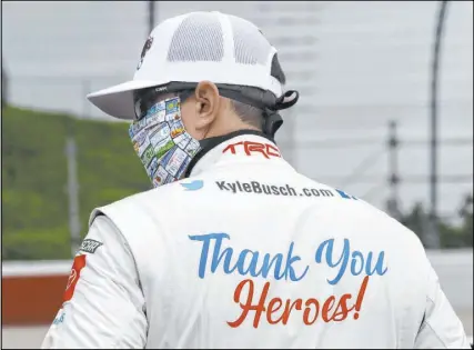  ?? Brynn Anderson The Associated Press ?? Las Vegas native Kyle Busch shows support for COVID-19 pandemic responders on the back of his firesuit Thursday prior to the NASCAR Xfinity Series Toyota 200 at Darlington (S.C.) Raceway.