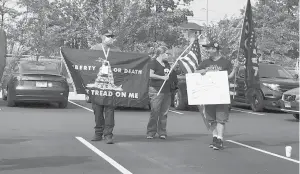  ?? COURTESY ?? A small group of protesters confronted Gov. Ned Lamont at a news conference in Windsor Locks Thursday to celebrate the completion of a redevelopm­ent project near the Hartford Line train station in town.