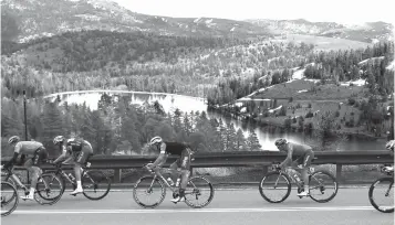  ?? Associated Press ?? ■ The peloton races down Highway 88 after crossing Carson Pass in the Central Sierra Nevada during the sixth stage of the Tour of California cycling race Friday near Kirkwood, Calif.