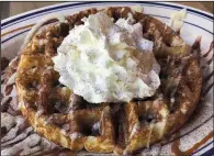  ?? Arkansas Democrat-Gazette/JENNIFER CHRISTMAN ?? The Churros Waffle comes loaded with sugary goodness — topped with cinnamon, caramel and Creme Anglaise — for brunch at Heights Taco & Tamale.