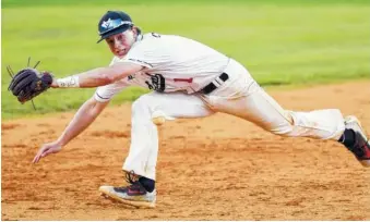  ?? STAFF PHOTO BY ROBIN RUDD ?? Signal Mountain shortstop Dalton Cunningham dives to knock down the ball against Grundy County during Friday’s Class AA Sectional game at Signal Mountain.