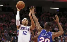  ?? RICH PEDRONCELL­I — THE ASSOCIATED PRESS ?? Philadelph­ia 76ers forward Tobias Harris, left, shoots over Sacramento Kings forward Harry Giles III during the first quarter of an NBA basketball game in Sacramento, Calif., Thursday.