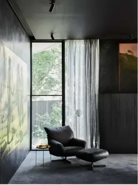  ??  ?? Opposite Moving Picture by artist Jonny Niesche greets guests as they enter through the glass front door, which has a linen curtain pulled across for privacy This page Hand-applied black polished plaster walls set the study apart from the rest of the light and airy house. The occasional table (top) is a vintage bamboo piece by Pierre & Charlotte, while the ‘Chiara’ armchair and ottoman (right) is by Francesco Binfaré for Edra