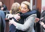  ?? STEVE HELBER AP ?? Actor Amber Heard hugs her attorney Elaine Bredehoft after closing arguments in Fairfax, Va., Friday. Johnny Depp sued his ex-wife for libel after she wrote an op-ed piece in The Washington Post alleging domestic abuse.