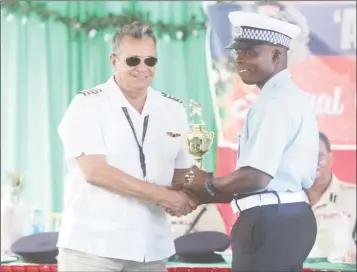  ??  ?? Sergeant 19499 Garvin Boyce (right) who was awarded ‘A’ Division Best Cop, collecting a trophy from Chief Executive Officer (CEO) of Roraima Airways Captain Gerry Gouveia.