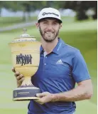  ?? AP PHOTO ?? WINNING SMILE: Dustin Johnson poses with his new trophy after winning the Bridgeston­e Invitation­al yesterday in Akron, Ohio.