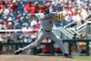  ?? The Associated Press ?? Arkansas starting pitcher Connor Noland (13) delivers to a Stanford batter in the first inning during an NCAA College World Series baseball game Saturday in Omaha, Neb.