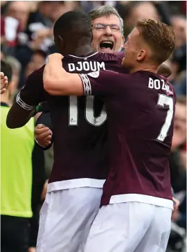  ??  ?? Manager Craig Levein, centre, and Ollie Bozanic, right, celebrate after Arnaud Djoum’s opening goal for Hearts