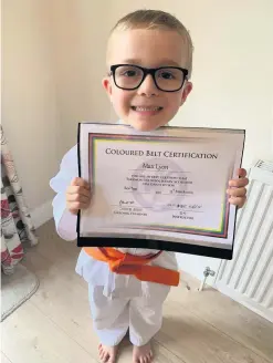  ??  ?? Delight Max Lyon with his certificat­e