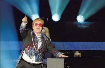  ?? Wally Skalij Los Angeles Times ?? ELTON JOHN performs at Dodger Stadium on Thursday. A man and woman possibly in their 60s were attacked when someone hit their car’s mirror in the parking lot. A bystander was punched too, the woman says.