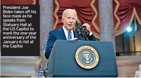  ?? ?? President Joe Biden takes off his face mask as he speaks from Statuary Hall at the US Capitol to mark the one-year anniversar­y of the January 6 riot at the Capitol