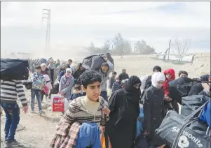  ?? AP PHOTO ?? This photo released by the Syrian official news agency SANA, shows Syrian civilians with their belongings, fleeing from fighting between the Syrian government forces and rebels, in Hamouria in eastern Ghouta, a suburb of Damascus, Syria, Thursday.