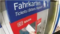  ??  ?? Ein Fahrgast hält ein Ticket vor einen Fahrkarten­automaten der Deutschen Bahn. Foto: Armin Weigel
