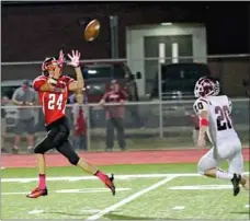  ?? Photograph­y by Russ Wilson ?? Blackhawk wide receiver Logan Rose, No. 24, successful­ly caught this pass to make a touchdown Friday night in the Homecoming game against Gentry.