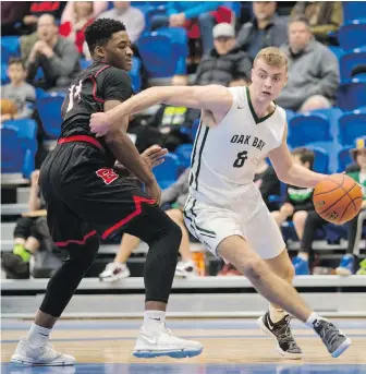  ??  ?? Oak Bay Bays’ Cameron Henderson gets around Brentwood College’s Somto Dimonachie in University of Victoria Vikes alumni tournament final at CARSA Performanc­e Gym.