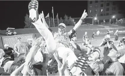  ?? MATT BUTTON /BALTIMORE SUN MEDIA GROUP ?? Players from Team Japan toss coach Katsumi Sekiguchi into the air as they celebrate after a victory in the Cal Ripken World Series.